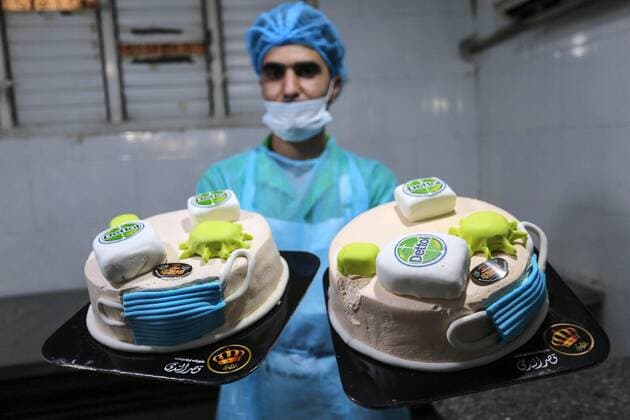 March 31, 2020, Khan Yunis, Gaza Strip, Palestinian Territory: Palestinians put final touches on cakes that portrays a woman wearing a facemask with model of bottel of Dettol to sterilize, at their shop in Khan Yunis in the southern Gaza Strip on March 31, 2020. The United Nations has warned that a COVID-19 outbreak in Gaza could be disastrous, given the high poverty rates and weak health system in the coastal strip under Israeli blockade since 2007. Authorities in Gaza have said that more than 2,700 Palestinians are in home-isolation, mostly people who had returned from Egypt Khan Yunis Palestinian Territory - ZUMAap3_ 20200331_zaf_ap3_106 Copyright: xAshrafxAmrax
