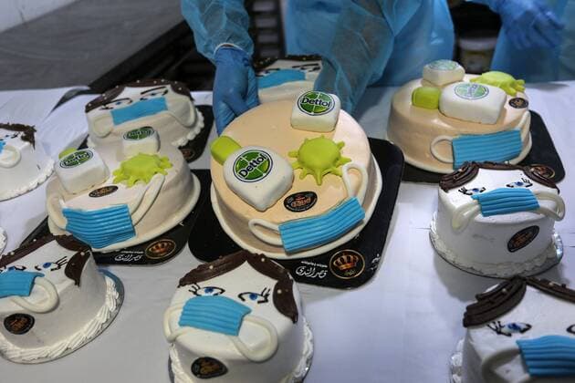 March 31, 2020, Khan Yunis, Gaza Strip, Palestinian Territory: Palestinians put final touches on cakes that portrays a woman wearing a facemask with model of bottel of Dettol to sterilize, at their shop in Khan Yunis in the southern Gaza Strip on March 31, 2020. The United Nations has warned that a COVID-19 outbreak in Gaza could be disastrous, given the high poverty rates and weak health system in the coastal strip under Israeli blockade since 2007. Authorities in Gaza have said that more than 2,700 Palestinians are in home-isolation, mostly people who had returned from Egypt Khan Yunis Palestinian Territory - ZUMAap3_ 20200331_zaf_ap3_107 Copyright: xAshrafxAmrax