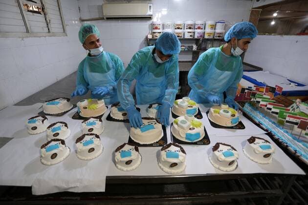 March 31, 2020, Khan Yunis, Gaza Strip, Palestinian Territory: Palestinians put final touches on cakes that portrays a woman wearing a facemask with model of bottel of Dettol to sterilize, at their shop in Khan Yunis in the southern Gaza Strip on March 31, 2020. The United Nations has warned that a COVID-19 outbreak in Gaza could be disastrous, given the high poverty rates and weak health system in the coastal strip under Israeli blockade since 2007. Authorities in Gaza have said that more than 2,700 Palestinians are in home-isolation, mostly people who had returned from Egypt Khan Yunis Palestinian Territory - ZUMAap3_ 20200331_zaf_ap3_144 Copyright: xAshrafxAmrax
