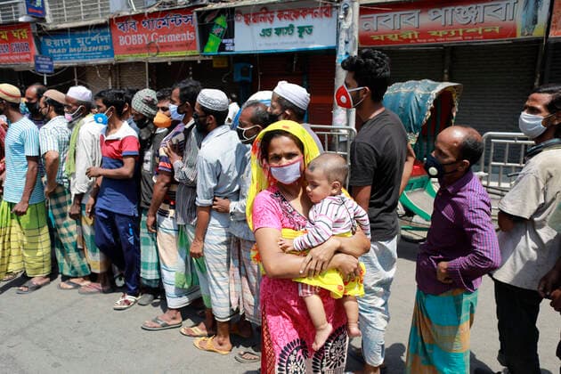 March 31, 2020, Dhaka, Bangladesh: People wait in a queue to get aid during the nationwide lockdown imposed as a measure to prevent the spread of COVID-19, in Dhaka, Bangladesh, March 31, 2020. A nationwide lockdown is going on all over the country to curb the spread of the novel COVID-19 in the wake of five deaths and at least 51 infections. Dhaka Bangladesh - ZUMAd117 20200331_zap_d117_001 Copyright: xSuvraxKantixDasx