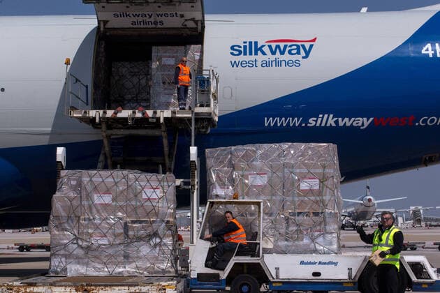 (200331) -- ATHENS, March 31, 2020 -- Workers unload boxes of surgical masks at the Athens international airport in Athens, Greece, on March 31, 2020. Greek Prime Minister Kyriakos Mitsotakis expressed his gratitude on Tuesday to all those who have helped in Greece s battle against the COVID-19 epidemic at a ceremony at the Athens international airport where 8.3 million surgical masks arrived from China. They were the second batch of a total of 13.5 million masks purchased and donated by the Onassis Foundation in Greece to the Greek state to be delivered to hospitals nationwide. ) GREECE-ATHENS-COVID-19-MASKS-ARRIVAL MariosxLolos 