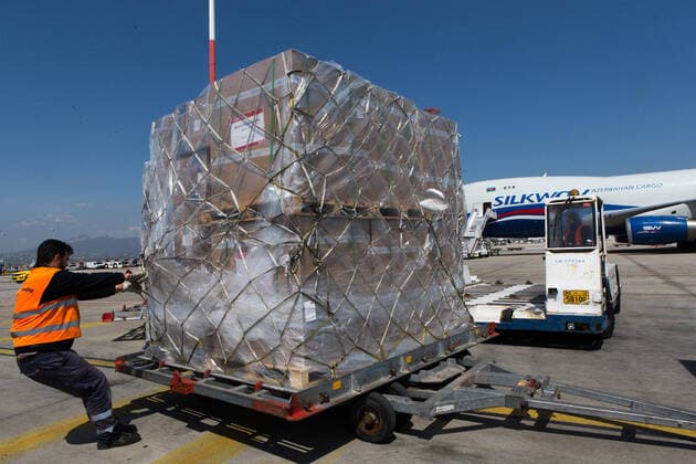 (200331) -- ATHENS, March 31, 2020 -- A worker unloads boxes of surgical masks at the Athens international airport in Athens, Greece, on March 31, 2020. Greek Prime Minister Kyriakos Mitsotakis expressed his gratitude on Tuesday to all those who have helped in Greece s battle against the COVID-19 epidemic at a ceremony at the Athens international airport where 8.3 million surgical masks arrived from China. They were the second batch of a total of 13.5 million masks purchased and donated by the Onassis Foundation in Greece to the Greek state to be delivered to hospitals nationwide. ) GREECE-ATHENS-COVID-19-MASKS-ARRIVAL MariosxLolos 