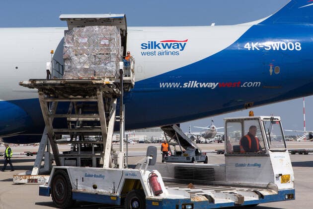 (200331) -- ATHENS, March 31, 2020 -- Workers unload boxes of surgical masks at the Athens international airport in Athens, Greece, on March 31, 2020. Greek Prime Minister Kyriakos Mitsotakis expressed his gratitude on Tuesday to all those who have helped in Greece s battle against the COVID-19 epidemic at a ceremony at the Athens international airport where 8.3 million surgical masks arrived from China. They were the second batch of a total of 13.5 million masks purchased and donated by the Onassis Foundation in Greece to the Greek state to be delivered to hospitals nationwide. ) GREECE-ATHENS-COVID-19-MASKS-ARRIVAL MariosxLolos 