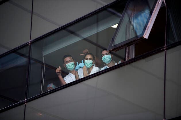 March 31, 2020, Granada, Spain: Health personnel at the San Cecilio clinical hospital returning the applause from the window..Since the start of the coronavirus outbreak and the state of alarm decreed by the Spanish government, people at 8pm as a tribute applaud the health personnel who return the applause from the different hospitals together with the police and members of civil protection. Granada Spain - ZUMAs197 20200331_zaa_s197_082 Copyright: xCarlosxGilx