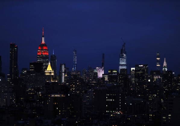 The Empire State Building light display is lit in the red and white colors of the Red Cross intended to honor emergency workers fighting coronavirus on Tuesday March 31, 2020 in New York City. The iconic Midtown skyscraper announced the debut of a display that began at 9 p.m. Monday, and will continue on through the course of the ongoing pandemic. New York s cases have topped 75,000 and 1,550 people have died.  NYP20200331130 JOHNxANGELILLO