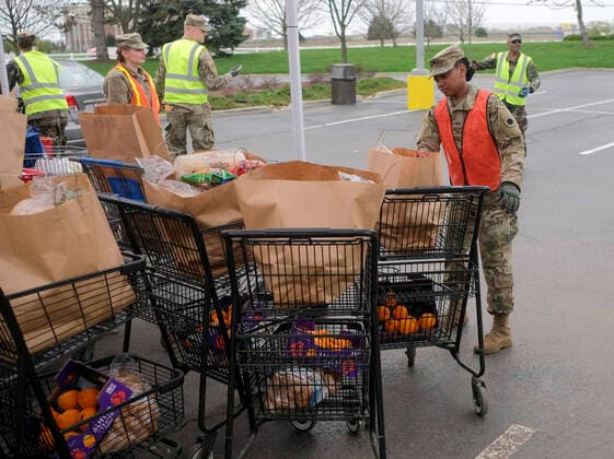 March 31, 2020, Columbus, Ohio, United States: Members of the Ohio National Guard help to pack food and supplies for those in need at the Mid Ohio Foodbank in Columbus..Due to the ongoing Coronavirus Pandemic and rising unemployment, the demand placed on Foodbanks around the United States has grown rapidly. The National Guard has been deployed to assist with the stocking, packaging, and distribution of food throughout the state. Columbus United States - ZUMAs197 20200331_zaa_s197_117 Copyright: xMatthewxHatcherx