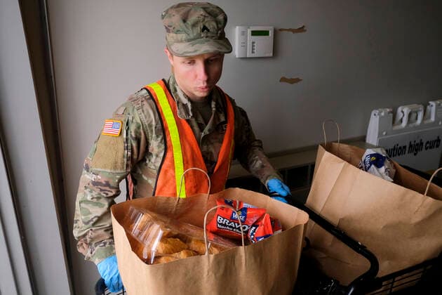 March 31, 2020, Columbus, Ohio, United States: A member of the Ohio National Guard helps to pack food and supplies for those in need at the Mid Ohio Foodbank in Columbus..Due to the ongoing Coronavirus Pandemic and rising unemployment, the demand placed on Foodbanks around the United States has grown rapidly. The National Guard has been deployed to assist with the stocking, packaging, and distribution of food throughout the state. Columbus United States - ZUMAs197 20200331_zaa_s197_119 Copyright: xMatthewxHatcherx