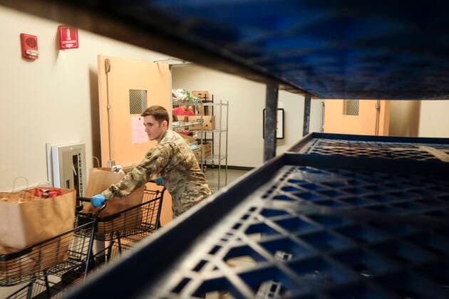 March 31, 2020, Columbus, Ohio, United States: A member of the Ohio National Guard helps to pack food and supplies for those in need at the Mid Ohio Foodbank in Columbus..Due to the ongoing Coronavirus Pandemic and rising unemployment, the demand placed on Foodbanks around the United States has grown rapidly. The National Guard has been deployed to assist with the stocking, packaging, and distribution of food throughout the state. Columbus United States - ZUMAs197 20200331_zaa_s197_120 Copyright: xMatthewxHatcherx
