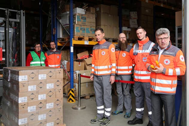 Rüdiger Unger mit Mitarbeitern beim Empfang einer Großspende von Händedesinfektionsmittelm der Beiersdorf AG an den Freistaat Sachsen bei der DRK Logistik HUB Sachsen GmbH. Dresden, 31.03.2020