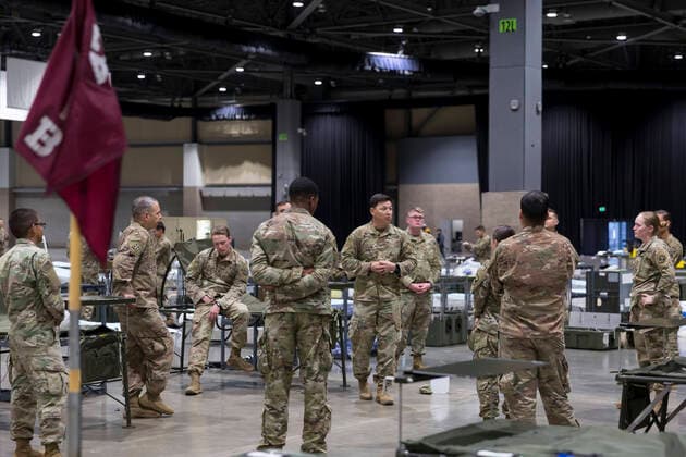 March 31, 2020, Seattle, Washington, U.S: Soldiers are briefed at the field hospital in CenturyLink Field Event Center in Seattle, Washington on March 31, 2020. Soldiers from the 627th Army Hospital at Fort Carson, Colorado are deploying a field hospital for non-COVID-19 cases that will house 150 beds when completed. Seattle U.S. - ZUMAg235 20200331_zap_g235_014 Copyright: xPaulxChristianxGordonx