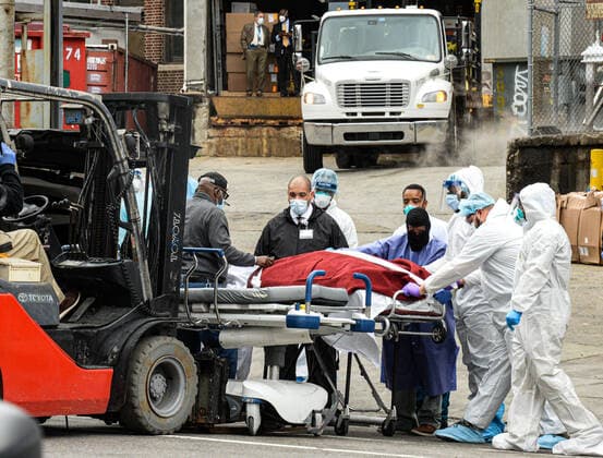 March 31, 2020, New York New York,, USA: A forklift is used to help as dead bodies are loaded onto a truck outside Brooklyn Hospital Center. The COVID-19 death toll in the city is 940 and 36,221 confirmed cases. NYC hospitals have been using bed sheets to wrap bodies because they no longer have body bags. New York USA - ZUMAs252 20200331_znp_s252_010 Copyright: xMarcusxSantosx
