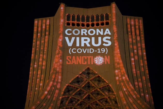 March 31, 2020, Tehran, Iran: A view at night of the lit-up Azadi (Freedom) tower with flags, messages of sympathy from all over the world over the ongoing novel coronavirus disease (COVID-19) pandemic, in Tehran, Iran. The appreciation message was also reflected in healthcare professionals who are trying to stop the pandemic in the country. The light display was organized by the city municipality. According to the latest reports by the Iranian Ministry of Health, over 2,000 people have died from the coronavirus infection throughout the country. Tehran Iran - ZUMAf146 20200331_zip_f146_012 Copyright: xRouzbehxFouladix