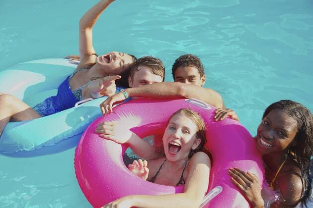 Portrait playful teenage friends enjoying pool party England Kent  Copyright: JuttaxKlee fStopImages1889037