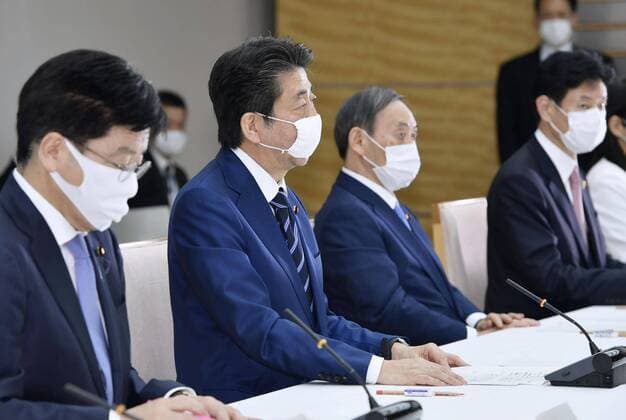 New coronavirus Japanese Prime Minister Shinzo Abe (2nd from L) attends a meeting of the government s coronavirus task force on April 1, 2020, in Tokyo. 