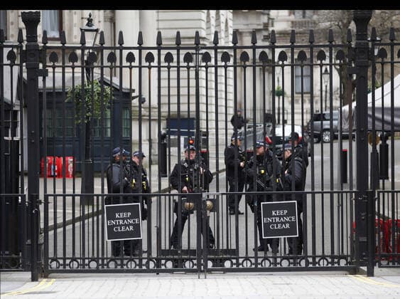 Day Nine of Lockdown in London. Armed police officers inside the security gates at Downing Street. The country is on lockdown due to the COVID-19 Coronavirus pandemic. People are not allowed to leave home except for minimal food shopping, medical treatment, exercise - once a day, and essential work. COVID-19 Coronavirus lockdown, London, UK, on April 1, 2020 