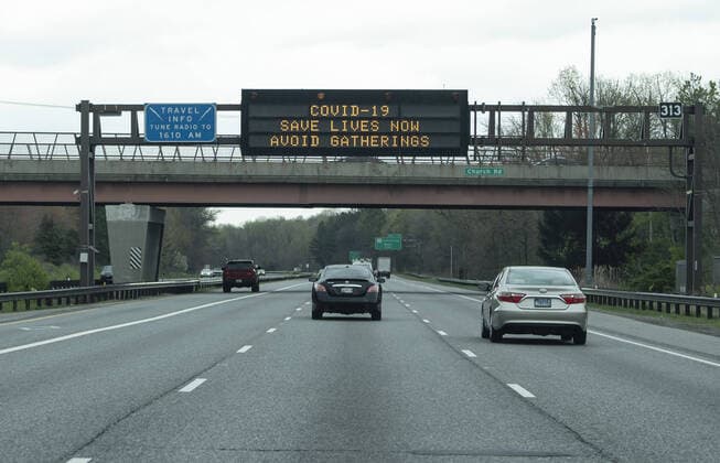 Drives pass under an electronic road sign urging people to stay home during the Coronavirus, COVID-19, pandemic, in Washington, D.C. on Wednesday, April 1, 2020.  WAP20200401301 KEVINxDIETSCH