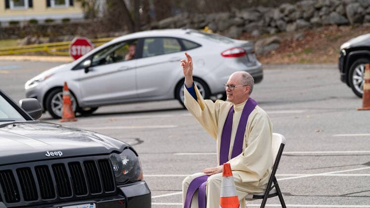 April 1, 2020, Chelmsford, Massachusetts, USA: Father Brian Mahoney hears at drive-up confessions in the parking lot of St. Marys Catholic Church during Covid-19 pandemic in Chelmsford.  (124964591)
