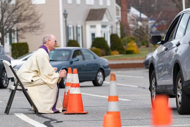 April 1, 2020, Chelmsford, Massachusetts, USA: Father Brian Mahoney hears at drive-up confessions in the parking lot of St. Marys Catholic Church during Covid-19 pandemic in Chelmsford.  (124964592)