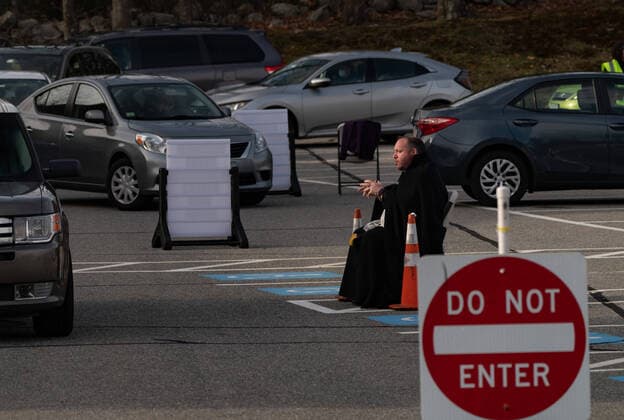 April 1, 2020, Chelmsford, Massachusetts, USA: Father Corey Bassett-Tirrell hears at drive-up confessions in the parking lot of St. Mary Catholic Church during Covid-19 pandemic in Chelmsford.  (124964601)