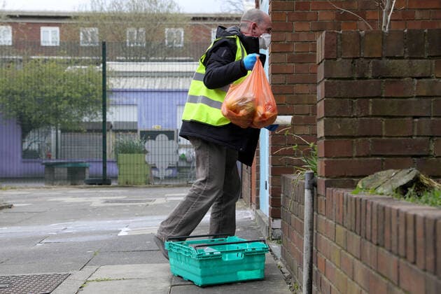 (200402) -- LONDON, April 2, 2020 (Xinhua) -- A volunteer from a distribution hub delivers food to a vulnerable person in London, Britain on April 1, 2020. The distribution hub was set up Monday by the Edible London food project, working in partnership with Haringey Council, in the underground car park at Tottenham Hotspur Stadium in London, for distribution of food to vulnerable groups. The British Government continues to try to combat the Coronavirus outbreak, while local authorities, community groups and charities are working to provide food for the most vulnerable in society. (Photo by Tim Ireland Xinhua) BRITAIN-LONDON-COVID-19-FOOD DISTRIBUTION 