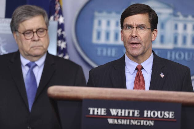 Defense Secretary Mark Esper speaks as US Attorney General William Barr listens, during the daily briefing on the novel coronavirus, COVID-19, in the Brady Press Briefing Room of the White House in Washington, DC on Wednesday, April 1, 2020.  WAX20200401227 OLIVERxCONTRERAS