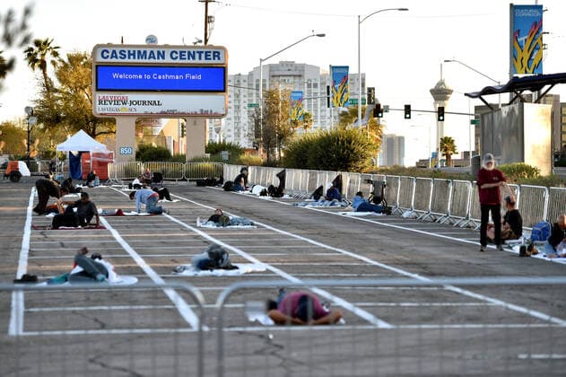 April 1, 2020 - Las Vegas, Nevada, U.S. - People prepare a place to sleep in an area marked by painted boxes at a temporary homeless shelter set up in a parking lot at Cashman Center amid the coronavirus pandemic on April 1, 2020, in Las Vegas, Nevada. Local officials opened the makeshift shelter after another local shelter closed when a homeless man staying there tested positive for the coronavirus. Las Vegas USA - ZUMAbk3_ 20200401_zaf_bk3_012 Copyright: xDavidxBeckerx
