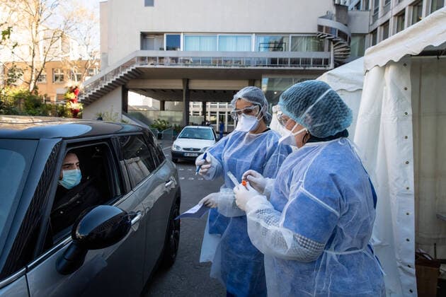 (200402) -- PARIS, April 2, 2020 (Xinhua) -- Medical biologists prepare to handle a swab to test a mediacal worker for the COVID-19 disease at a COVID-19 drive-in test center in Paris, France, April 1, 2020. A COVID-19 drive-in and screening center has opened at the City Hall of the 17th arrondissement of Paris in partnership with three laboratories in the arrondissement and is dedicated to healthcare professionals. (Photo by Aurelien Morissard Xinhua) FRANCE-PARIS-CORONAVIRUS-DRIVE IN TEST 