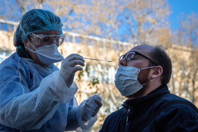 (200402) -- PARIS, April 2, 2020 (Xinhua) -- A medical biologist handles a swab to test a mediacal worker for the COVID-19 disease at a COVID-19 drive-in test center in Paris, France, April 1, 2020. A COVID-19 drive-in and screening center has opened at the City Hall of the 17th arrondissement of Paris in partnership with three laboratories in the arrondissement and is dedicated to healthcare professionals. (Photo by Aurelien Morissard Xinhua) FRANCE-PARIS-CORONAVIRUS-DRIVE IN TEST 