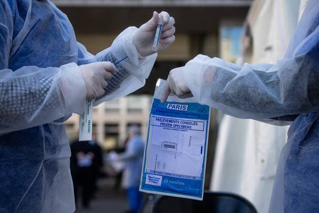 (200402) -- PARIS, April 2, 2020 (Xinhua) -- Medical biologists prepare to handle a swab to test a mediacal worker for the COVID-19 disease at a COVID-19 drive-in test center in Paris, France, April 1, 2020. A COVID-19 drive-in screening center has opened at the City Hall of the 17th arrondissement of Paris in partnership with three laboratories in the arrondissement and is dedicated to healthcare professionals. (Photo by Aurelien Morissard Xinhua) FRANCE-PARIS-CORONAVIRUS-DRIVE IN TEST 
