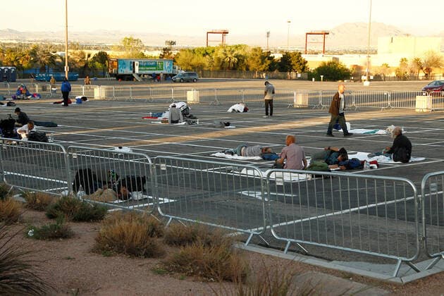 Homeless individuals practice self-distancing measures at the Cashman Center parking lot during the Coronavirus closure in Las Vegas, Nevada on Wednesday, April 1, 2020.  LAV2020040101 JAMESxATOA