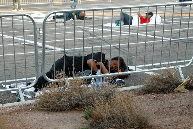 An individual sleeps in a temporary open air homeless shelter at the Cashman Center parking lot during the Coronavirus closure of Hotels and Casino s in Las Vegas, Nevada on Wednesday, April 1, 2020.  LAV2020040105 JAMESxATOA