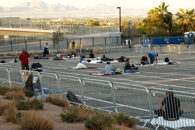 A view of homeless individuals practicing self-distancing measures at a temporary shelter at the Cashman Center parking lot during the Coronavirus closure in Las Vegas, Nevada on Wednesday, April 1, 2020.  LAV2020040102 JAMESxATOA