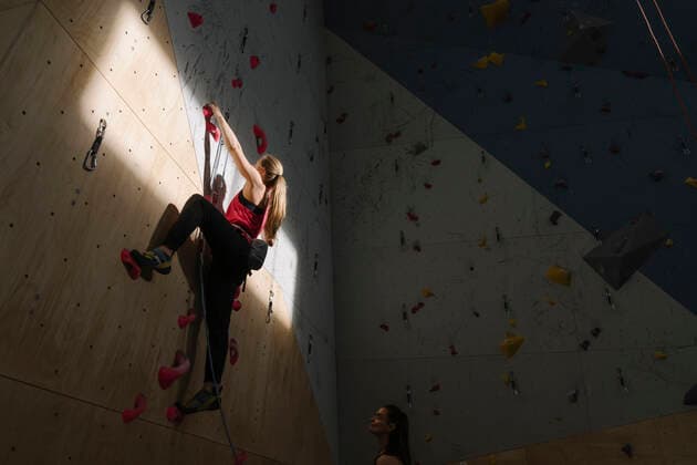 Woman climbing on the wall in climbing gym with sunlight and shadow model released Symbolfoto property released  AHSF01925