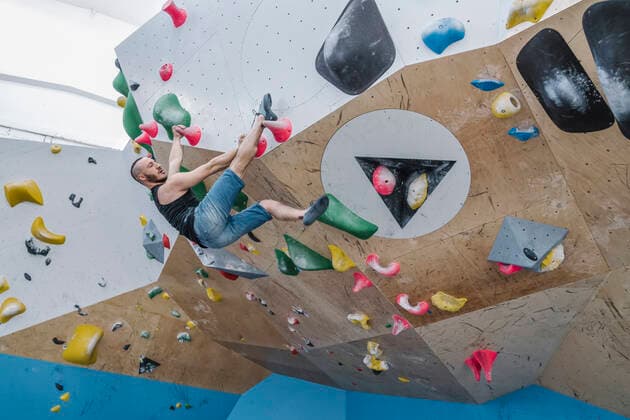 Man bouldering in climbing gym model released Symbolfoto property released  AHSF01936