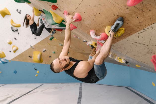 Man and woman bouldering in climbing gym model released Symbolfoto property released  AHSF01946