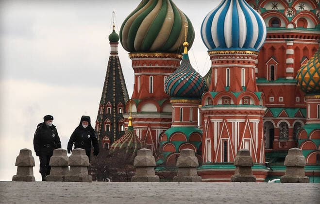 MOSCOW, RUSSIA - APRIL 2, 2020: Police officers seen by St Basil s Cathedral in Red Square. The Moscow authorities imposed home isolation for all Moscow residents, regardless of their age, and restrictions on movement within the city, effective since March 30, 2020, as a measure to contain the spread of the COVID-19 coronavirus infection. Violations of the stay-at-home order carry fines ranging from 1,000 to 40,000 rubles for non-infected people, and up to 1m rubles or imprisonment for up to 3 years for infected people, depending on the severity of consequences. Valery Sharifulin TASS TS0D43B7