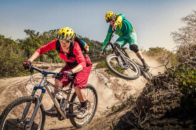 Man and woman on mountainbikes riding on trail, Fort Ord National Monument Park, Monterey, California, USA model released Symbolfoto  MSUF00204