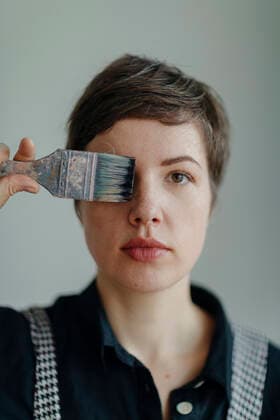Portrait of a female painter holding a paintbrush model released Symbolfoto property released  OGF00253