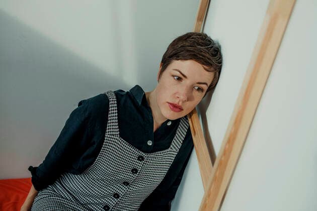 Portrait of a serious female painter with a picture frame in her studio model released Symbolfoto property released  OGF00258