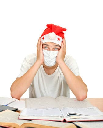 Sick Student in Santas Hat Sick Student in Santa s Hat and Flu Mask. Isolated on the white background  Copyright: xsabphotox 9675402