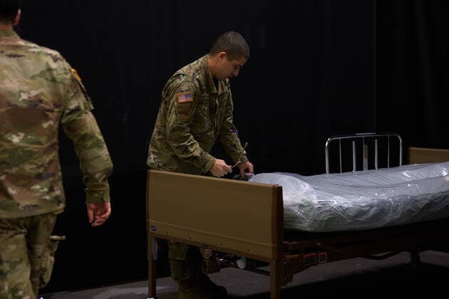 April 2, 2020, Worcester, Massachusetts, US: The Massachusetts National Guard in cooperation with FEMA and Umass Memorial Medical Cenetr are building a COVID-19, Corona Virus, field hospital to treat midlly ill paitents at the DCU Center in Worcester, Massachusetts. The facility will have 250 beds for those who are too sick to be home, but not in need of an Intensive Care Unit. Soldiers assemble a hospital bed. Worcester US - ZUMAd211 20200402_zap_d211_021 Copyright: xAllisonxDinnerx