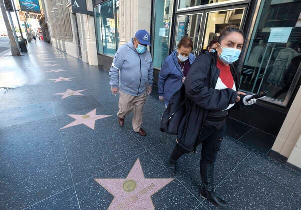 April 2, 2020, Los Angeles, California, U.S: People wearing face masks walk along the Hollywood Walk on April 2, 2020 in Los Angeles. Los Angeles Mayor Eric Garcetti is advising the public to wear any kind of protective face covering when going out -- even a scarf or other clothing item -- to reduce the spread of the coronavirus. Los Angeles U.S. - ZUMAc68_ 20200402_zaf_c68_012 Copyright: xRingoxChiux