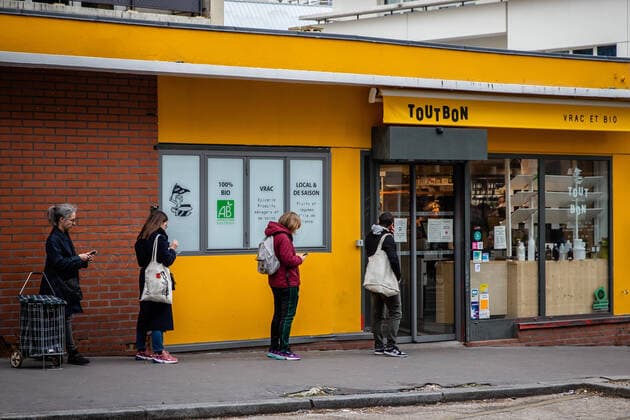 (200403) -- PARIS, April 3, 2020 (Xinhua) -- Customers line up with a distance outside a shop in Paris, France, April 2, 2020. French hospitals registered a one-day loss of 471 coronavirus patients, taking the total to 4,503, while some 900 dependant elder people living at nursing homes had died of the virus since the epidemic began, a health official said on Thursday. In total, 59,105 people had tested positive for the virus, up by 2,116 in one day, versus an increase of 4,861 on Wednesday, said Director General of Health Jerome Salomon at the daily conference on the epidemic. (Photo by Aurelien Morissard Xinhua) FRANCE-PARIS-COVID-19 