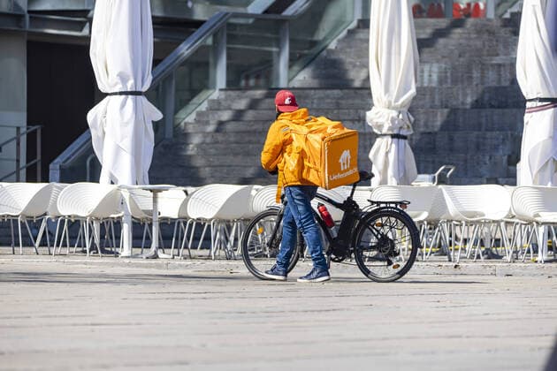 DEU, Deutschland, Baden-Württemberg, Stuttgart, 03.04.2020: Gefragte Dienstleistung während der Corona-Krise. Fahrradkuriere des Lieferdienstes Lieferando verbuchen wegen geschlossener Restaurants steigende Umsätze.