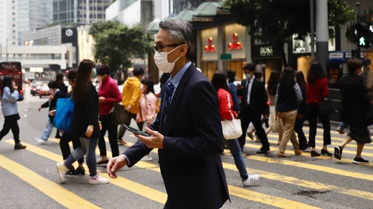 April 3, 2020, Hong Kong, CHINA: Well dressed man with facemask crossing the zebra at financial hub in Central. According to WHO, global infections of coronavirus introduced by China Pneumonia is almost reaching 1 million mark, continue spreading in alarming speed showing no sign of dissipation.April-3,2020 Hong Kong.ZUMA Hong Kong CHINA - ZUMAl137 20200403_zap_l137_003 Copyright: xLiauxChung-renx