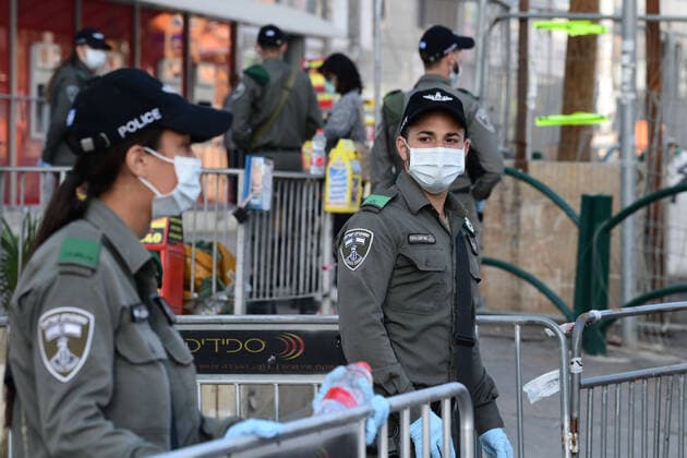 (200403) -- BNEI BRAK, April 3, 2020 (Xinhua) -- Israeli Border Police block the main road in the central Israeli city of Bnei Brak on April 3, 2020. The Israeli government has declared the Jewish ultra-Orthodox city of Bnei Brak a restricted area because of the high infection rate of COVID-19, Israel s Prime Minister Office said Thursday. (JINI Handout via Xinhua) MIDEAST-BNEI BRAK-COVID-19 