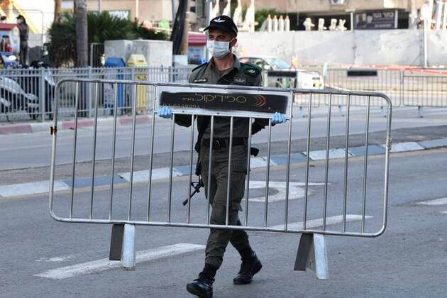 (200403) -- BNEI BRAK, April 3, 2020 (Xinhua) -- Israeli Border Police block the main road in the central Israeli city of Bnei Brak on April 3, 2020. The Israeli government has declared the Jewish ultra-Orthodox city of Bnei Brak a restricted area because of the high infection rate of COVID-19, Israel s Prime Minister Office said Thursday. (JINI Handout via Xinhua) MIDEAST-BNEI BRAK-COVID-19 