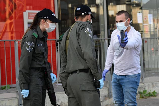 (200403) -- BNEI BRAK, April 3, 2020 (Xinhua) -- Israeli Border Police block the main road in the central Israeli city of Bnei Brak on April 3, 2020. The Israeli government has declared the Jewish ultra-Orthodox city of Bnei Brak a restricted area because of the high infection rate of COVID-19, Israel s Prime Minister Office said Thursday. (JINI Handout via Xinhua) MIDEAST-BNEI BRAK-COVID-19 