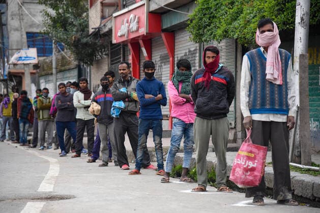 April 3, 2020, Srinagar, Jammu & Kashmir, India: Non local workers maintain the social distance as a preventive measure while in queue receiving aid from a local non government organisation, during the lockdown..Indian Prime Minister, Narendra Mondi announced 21 day lockdown on 22 March across the country restricting the movement of people from stepping out of their home to curb the spread of the corona virus. More than 2500 tested positive for corona virus in India with 71 deaths. Srinagar India - ZUMAs197 20200403_zaa_s197_073 Copyright: xIdreesxAbbasx