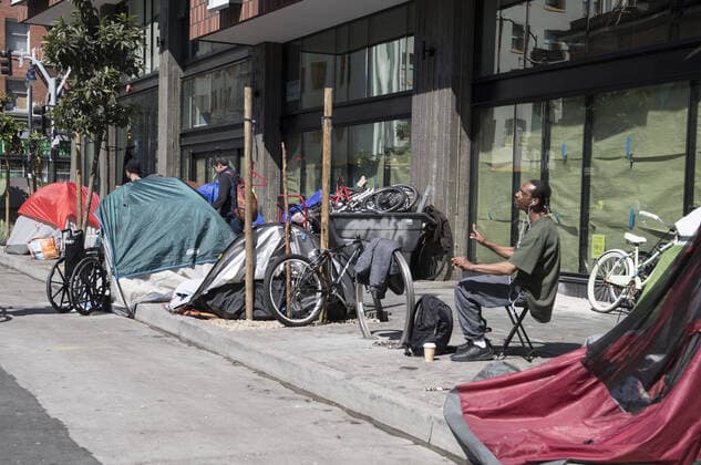 Tents and homeless occupy the sidewalk on Eddy Street in the Tenderloin district of San Francisco on Friday, April 3, 2020. San Francisco is trying to spread out their homeless to avoid the coronavirus.  SXP2020040304 TERRYxSCHMITT